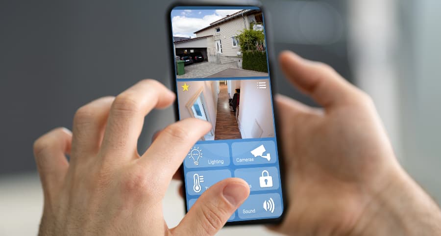 Homeowner checking surveillance camera feeds on a smartphone